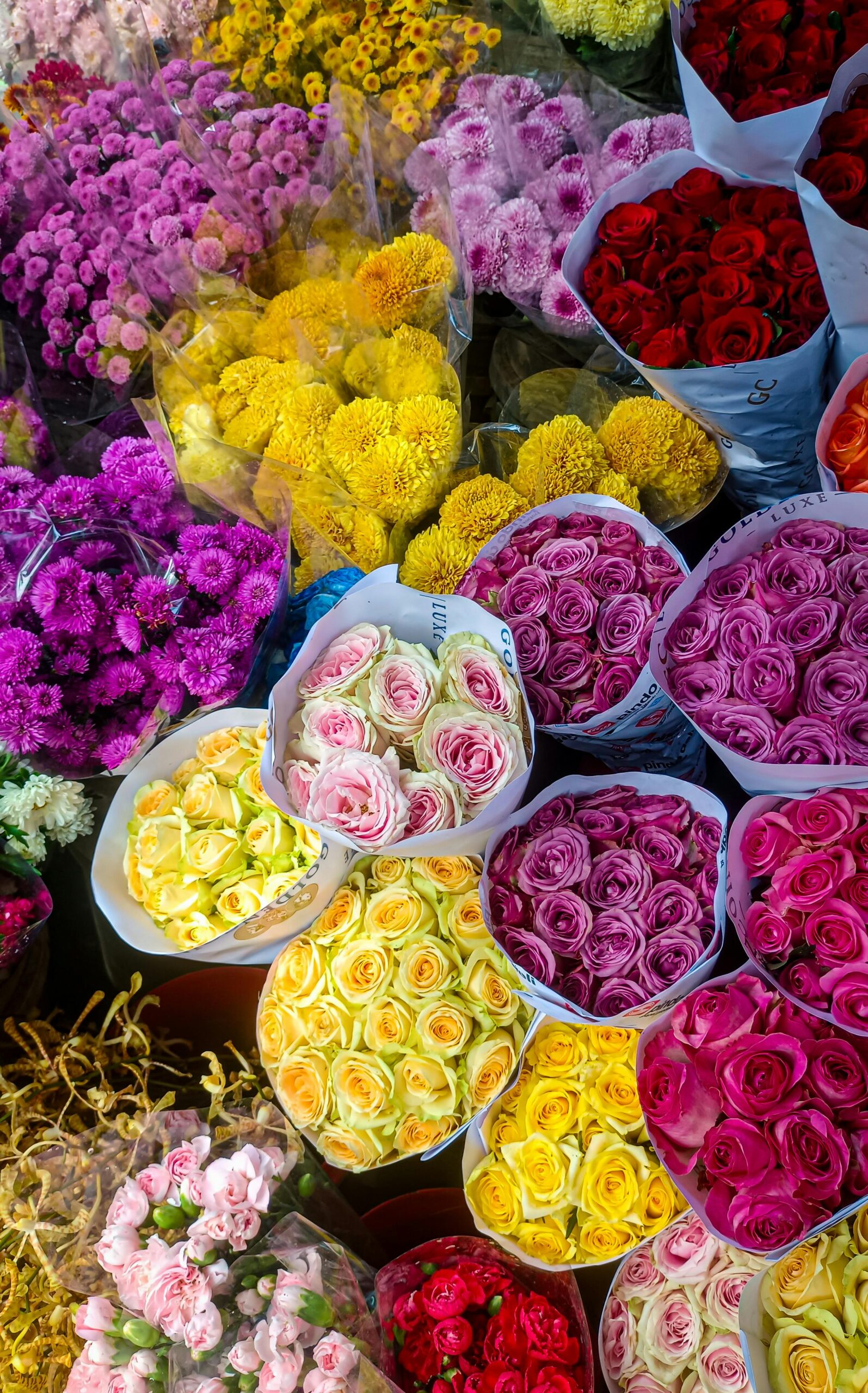 Vibrant bouquets of roses and chrysanthemums at South Jakarta flower market.
